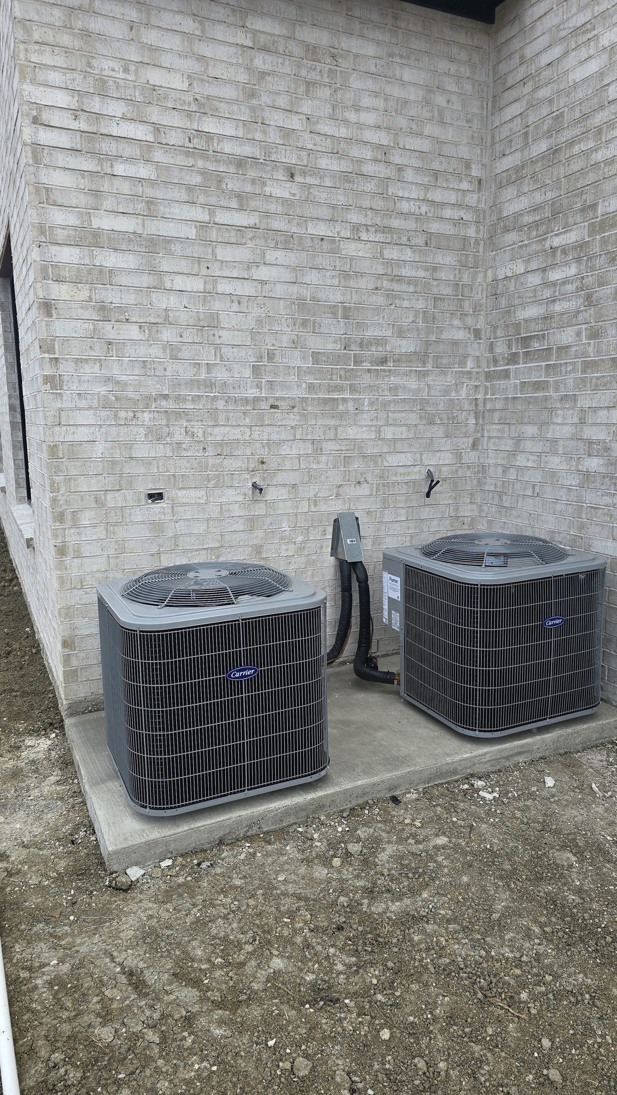 New Greentech USA air conditioning condenser units installed on a clean concrete pad