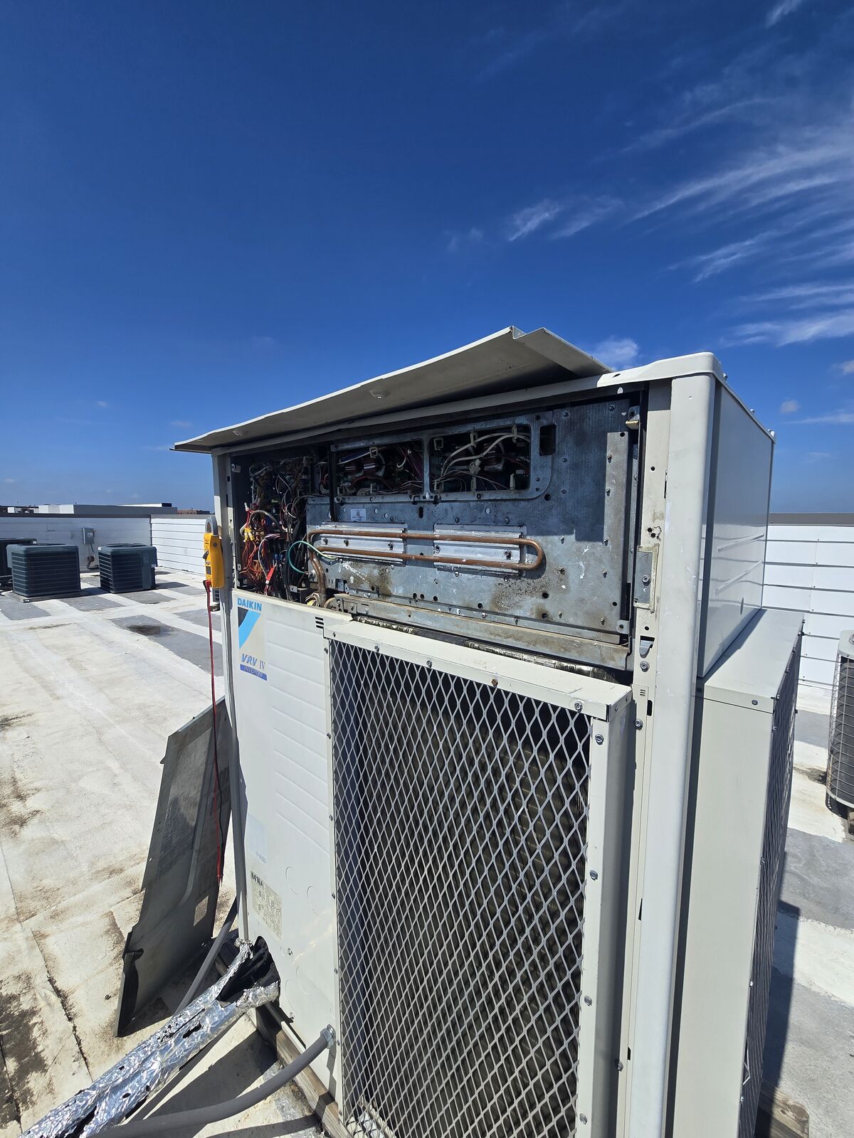 Rooftop unit with the access panel removed showing the coil and internal compartment